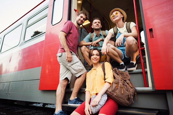 Low angle view of a group of friends at the exit of the train posing for the photo