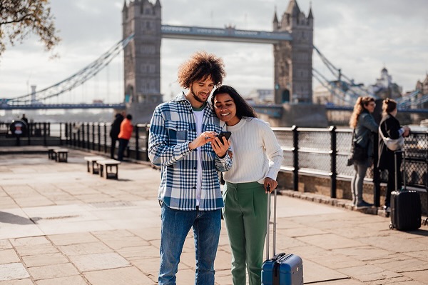A married couple using their phone to navigate the city.